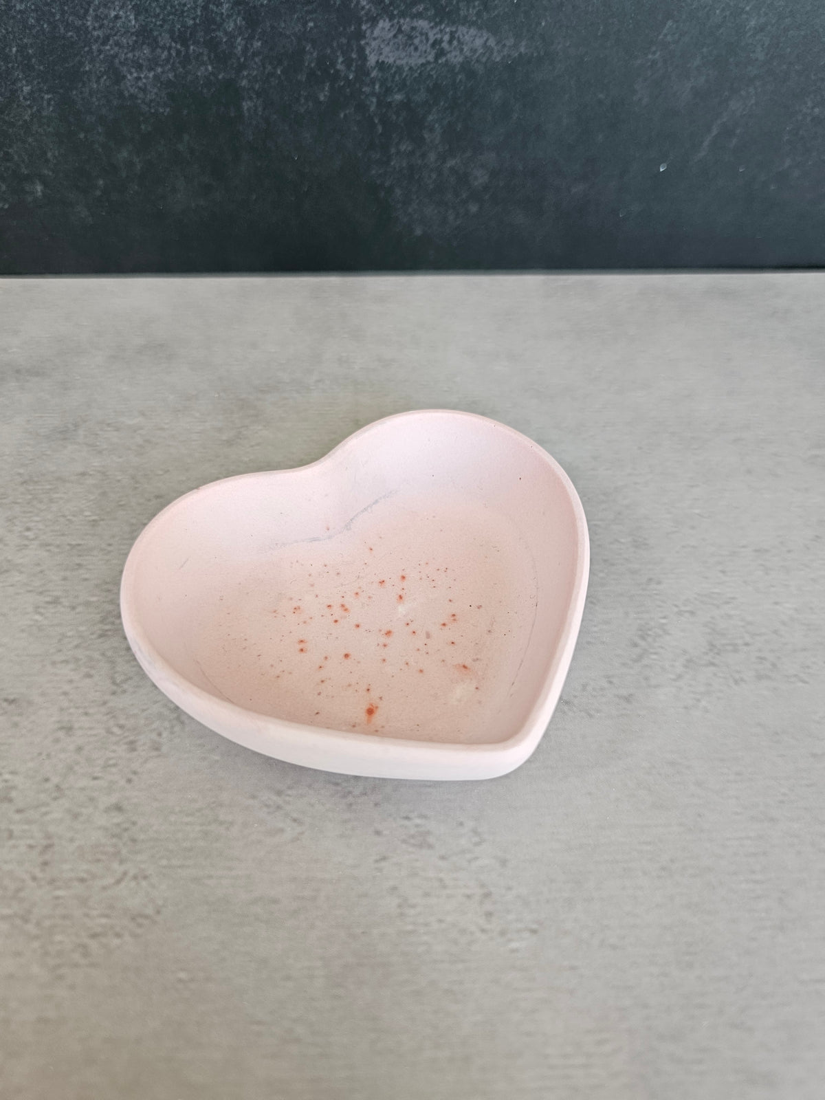 Small heart-shaped trinket bowl or dish with small red speckles