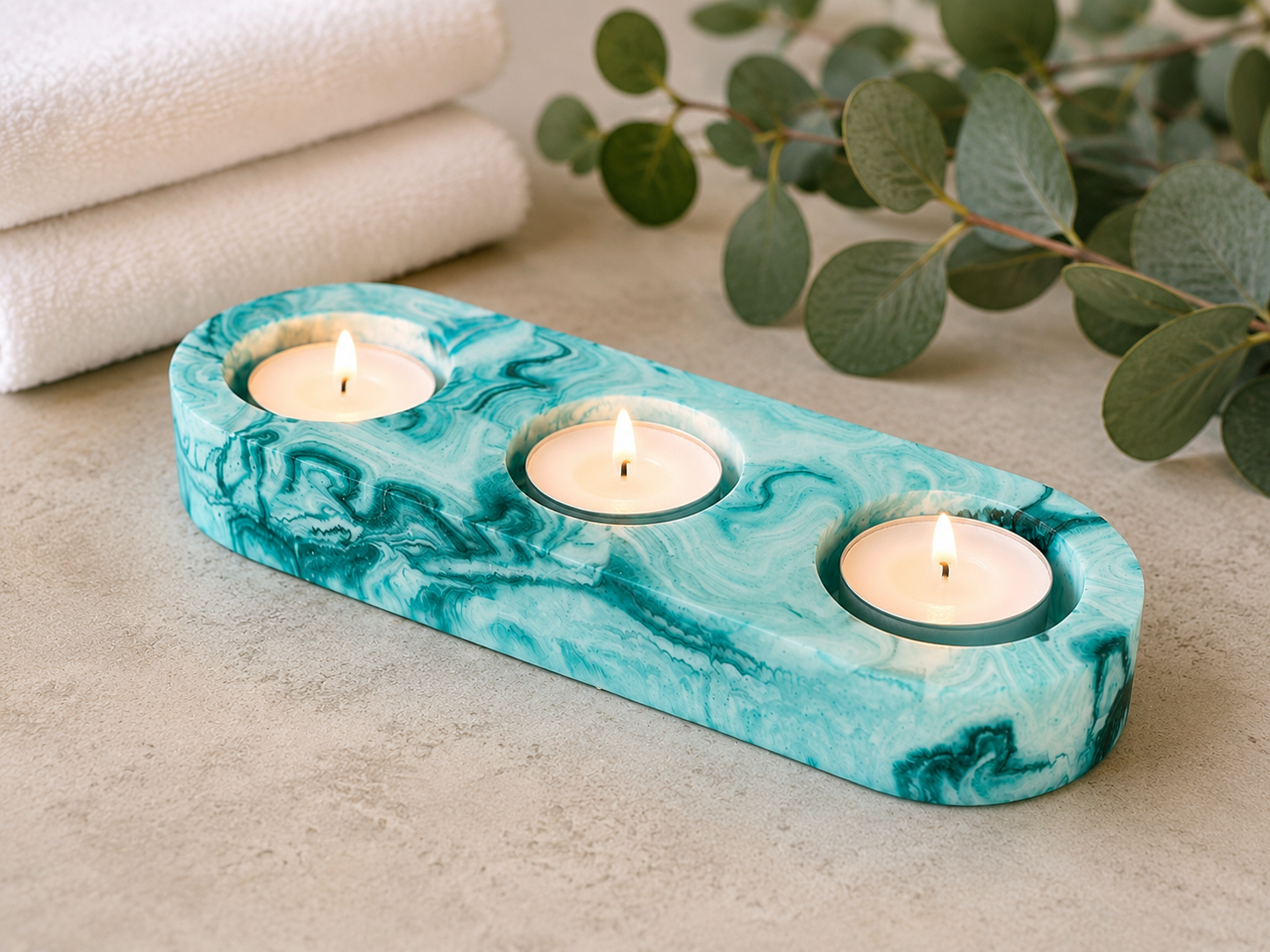Handcrafted aqua and white resin triple tealight candle holder with ocean-inspired marbled design.