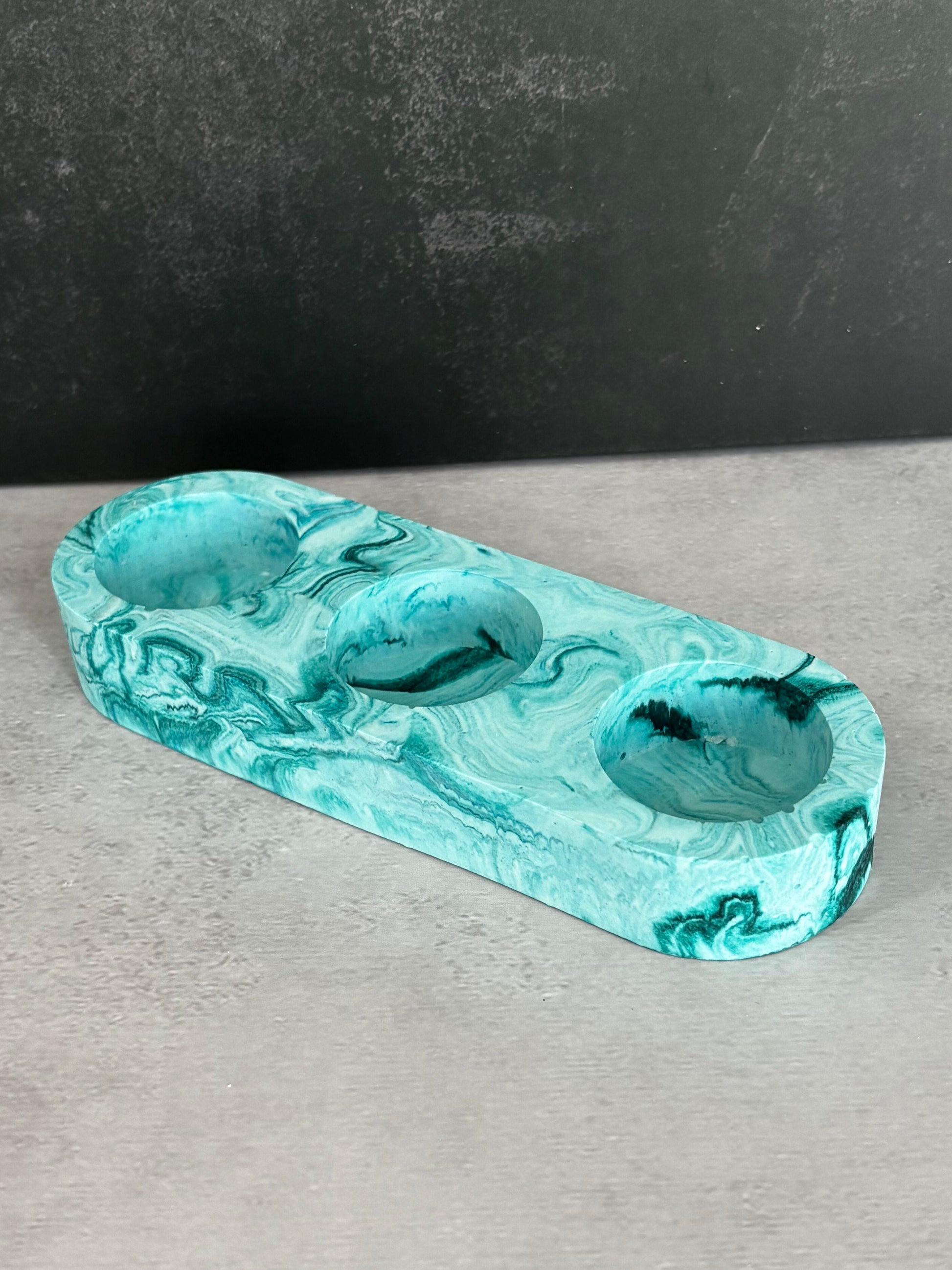 Handcrafted aqua and white resin triple tealight candle holder with ocean-inspired marbled design.