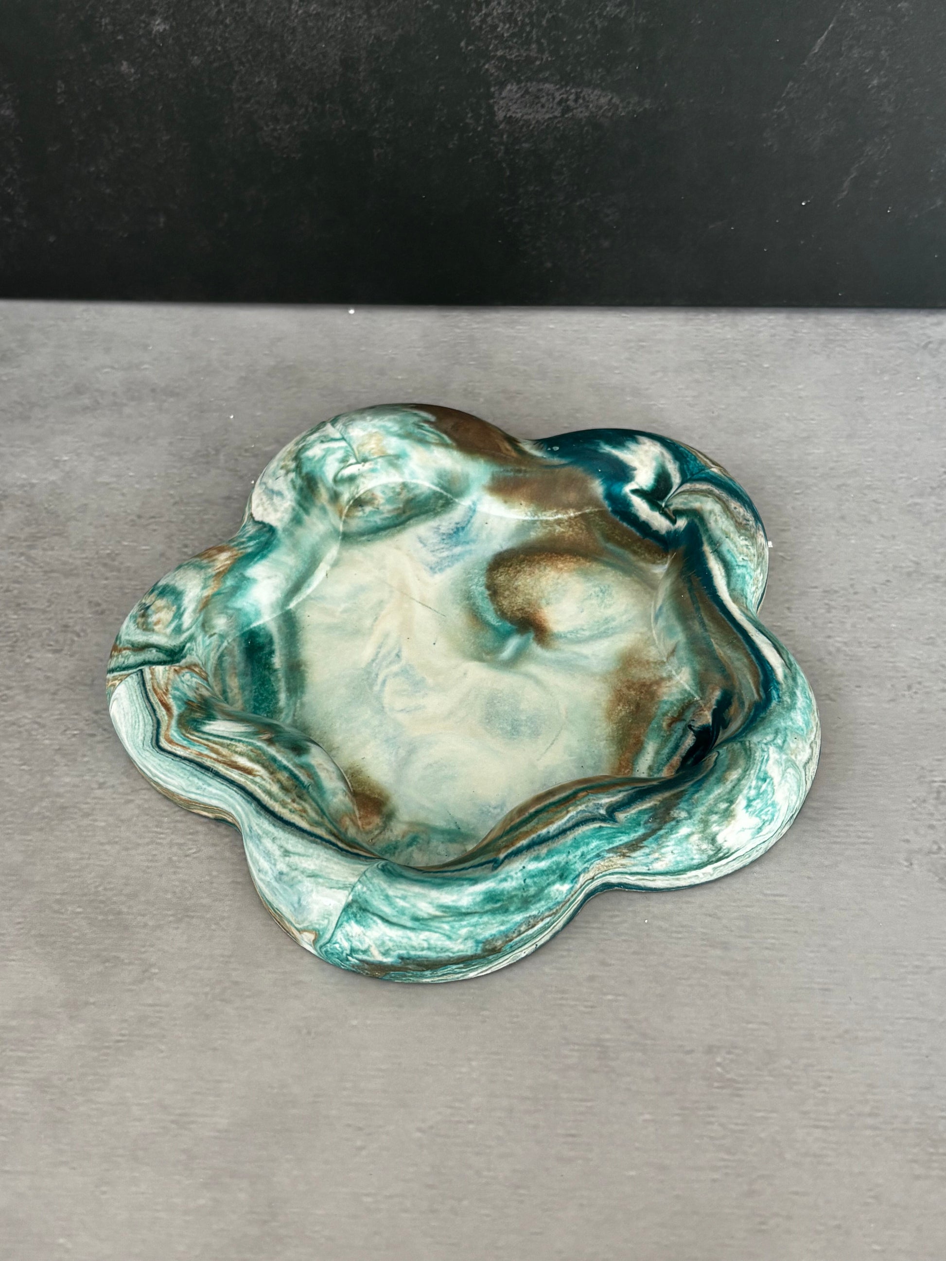Handcrafted botanical green resin catchall dish with floral-inspired shape and marbled finish